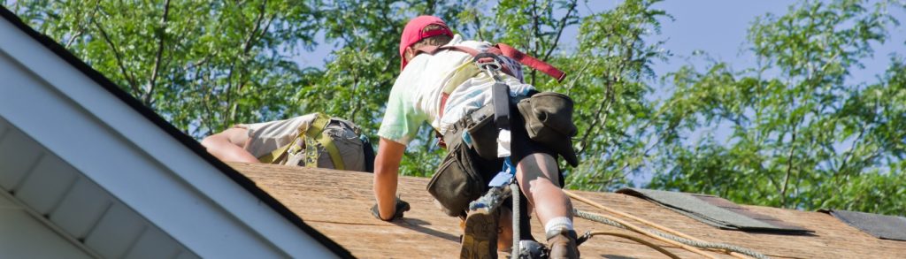 Professional roofers carrying out roof repairs using safe scaffolding access